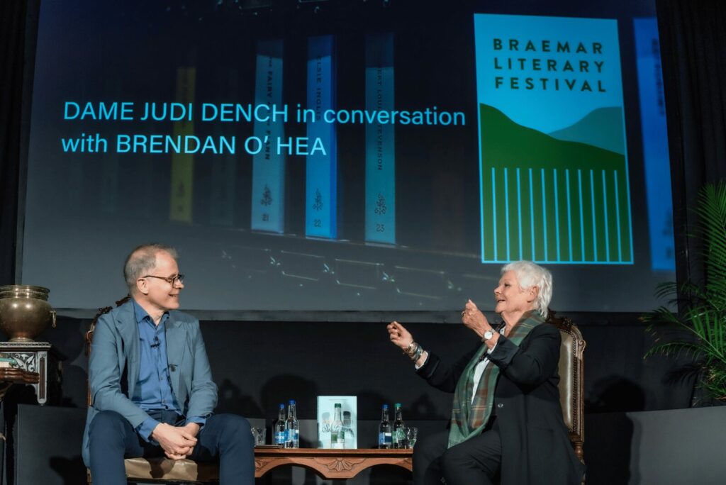 Dame Judy Dench speaking on stage at the Braemar Literary Festival | The Fife Arms