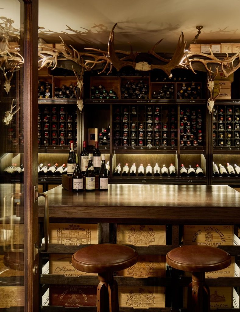 The cellar at the Fife Arms hotel with wine on the table.