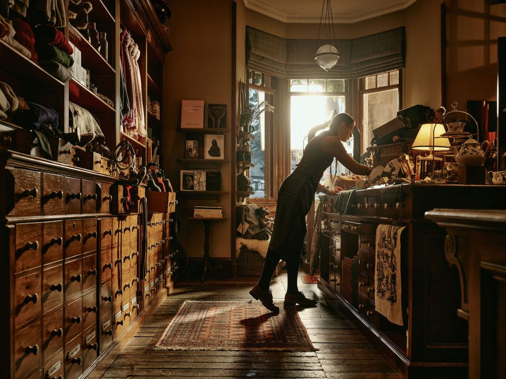 Staff member in the shop organising the displays