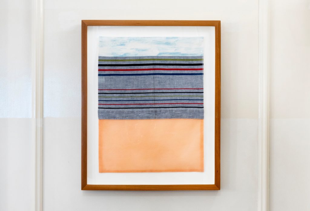 A textile work of art in a wooden frame