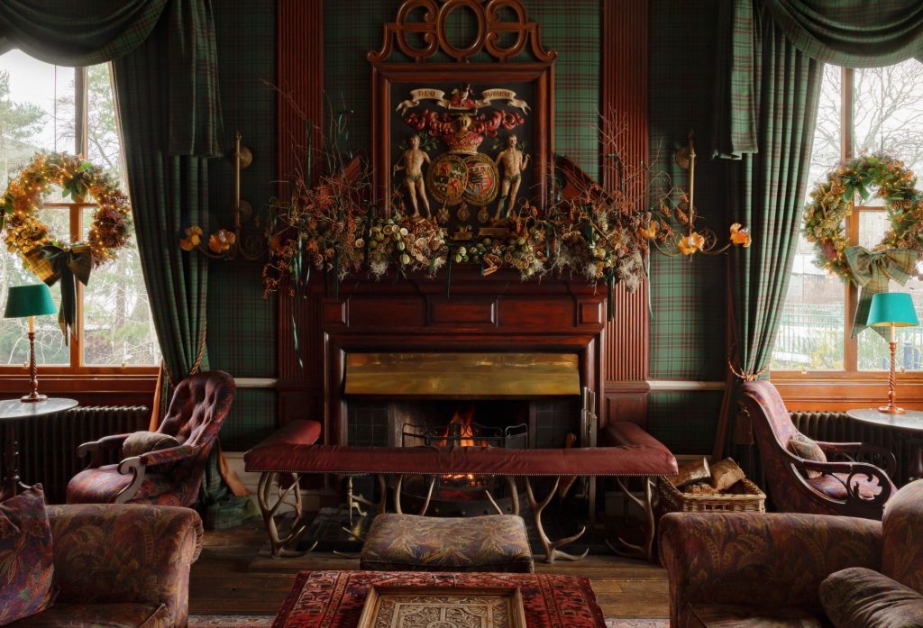 Christmas decorations around a Victorian fireplace in a drawing room