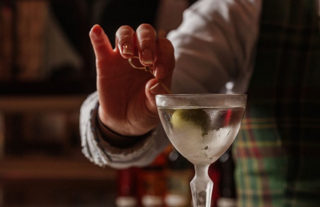 Adding the garnish to a martini in Elsa's Cocktail Bar