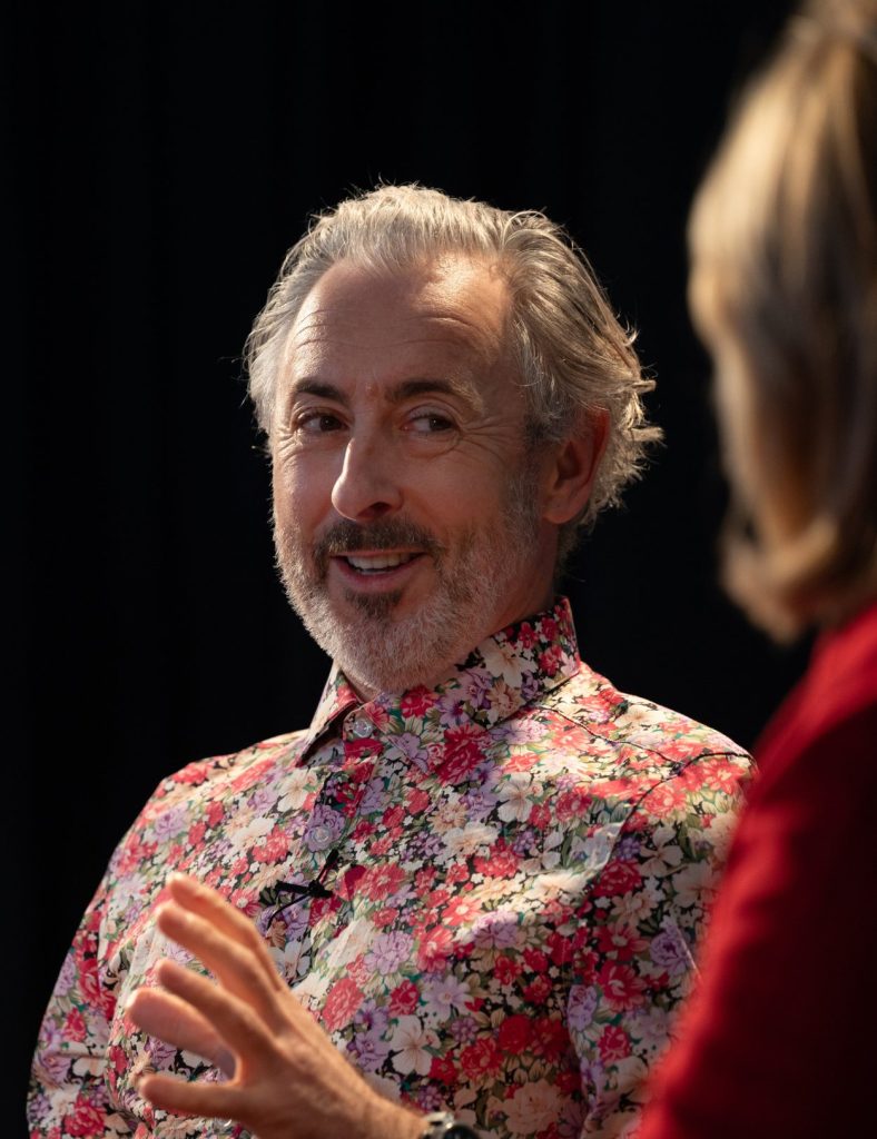 Alan Cummin wearing a floral shirt.
