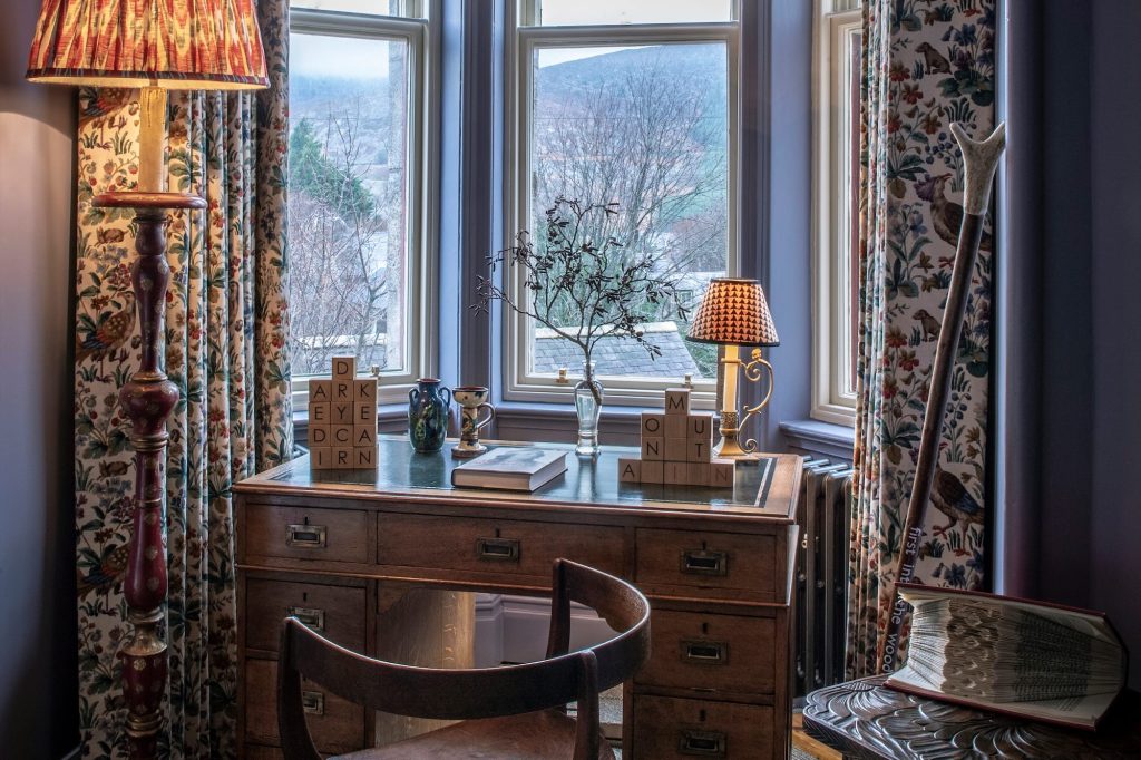 A desk and chair in a bay window in the Nan Shepherd room