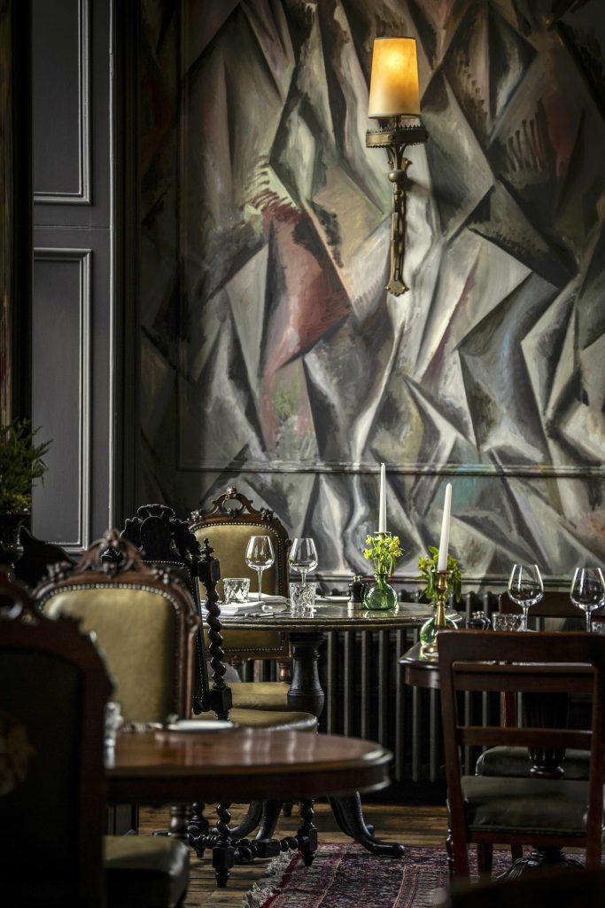 A corner of The Clunie Dining Room with painted mural by artist Guillermo Kuitca