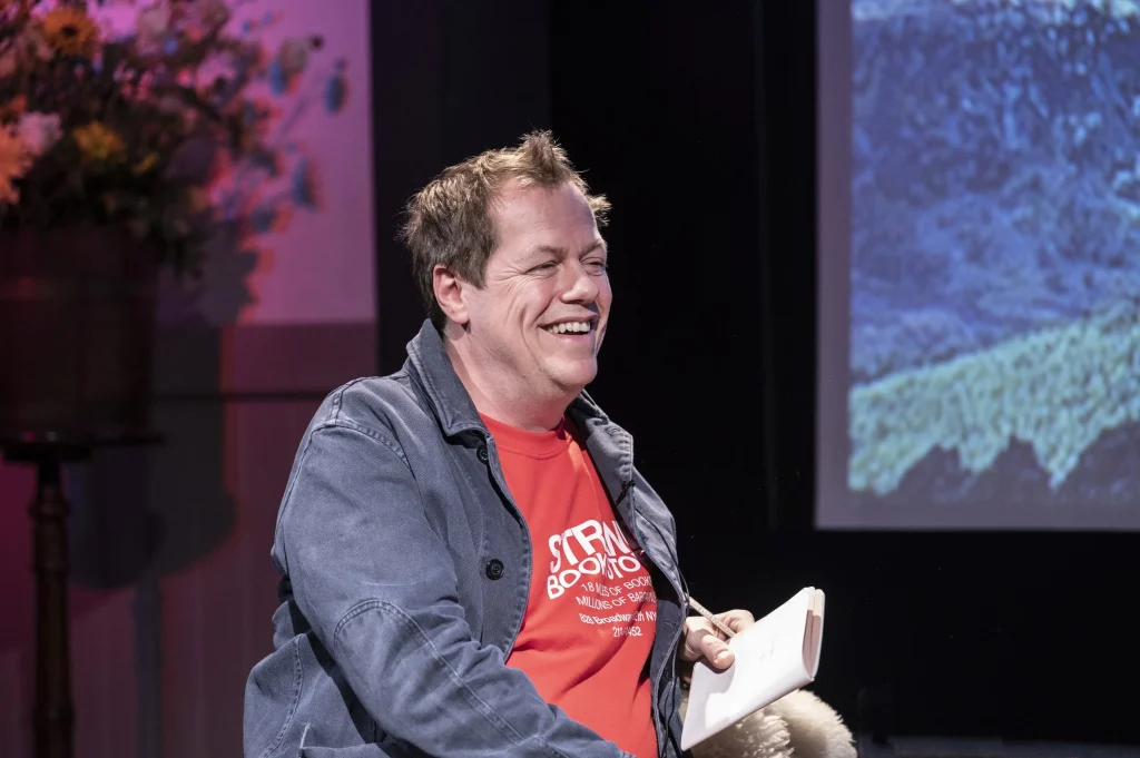 Tom Parker Bowles wearing a red tshirt talking