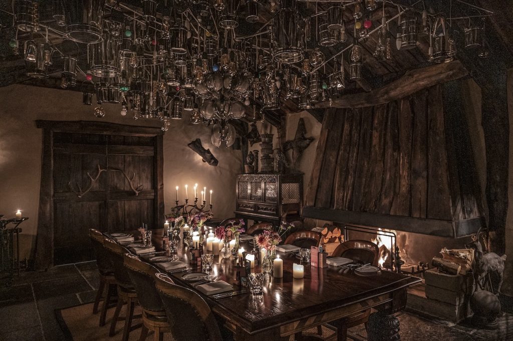 The atmospheric Fire Room with a table set for a private event with candles and flowers