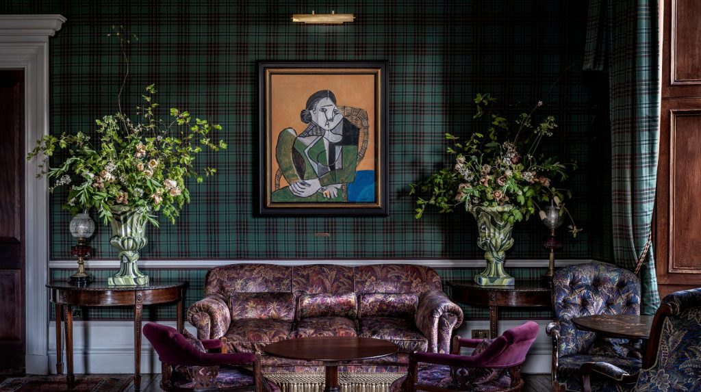Picasso 'Femme assise dans un fauteuil' hanging on a tartan wall