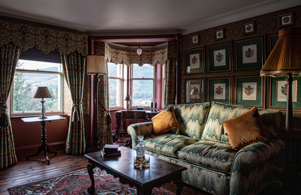 The sitting area beside bay windows in the Coat of Arms suite