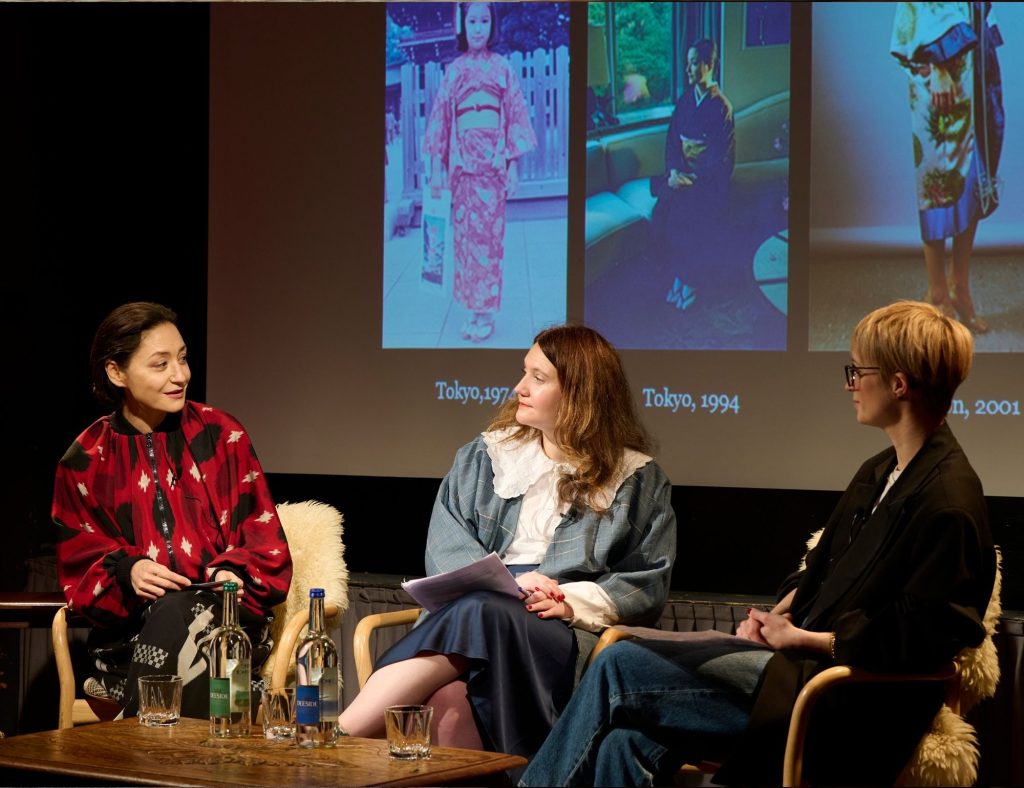 Kazu Huggler on-stage discussing the kimono at Festival of Fashion in 2024