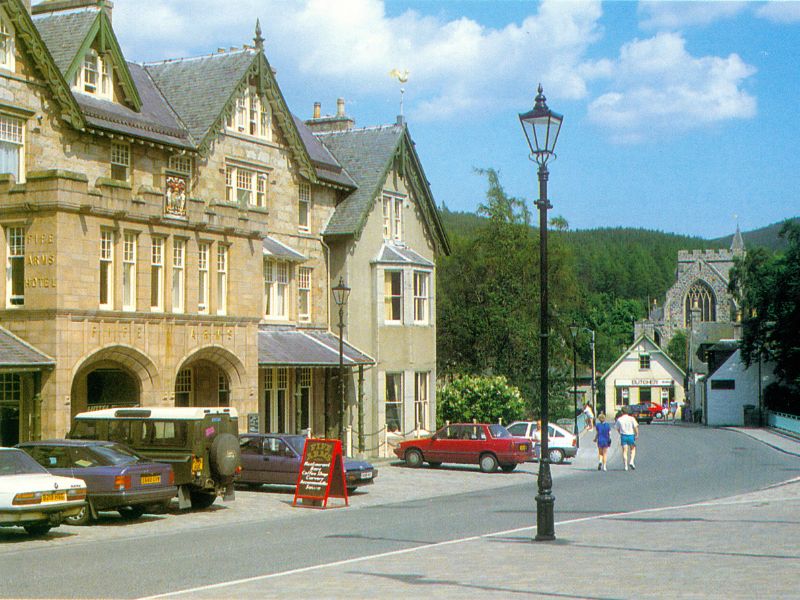 Exterior of the Fife Arms hotel during the summer with cars parked outside