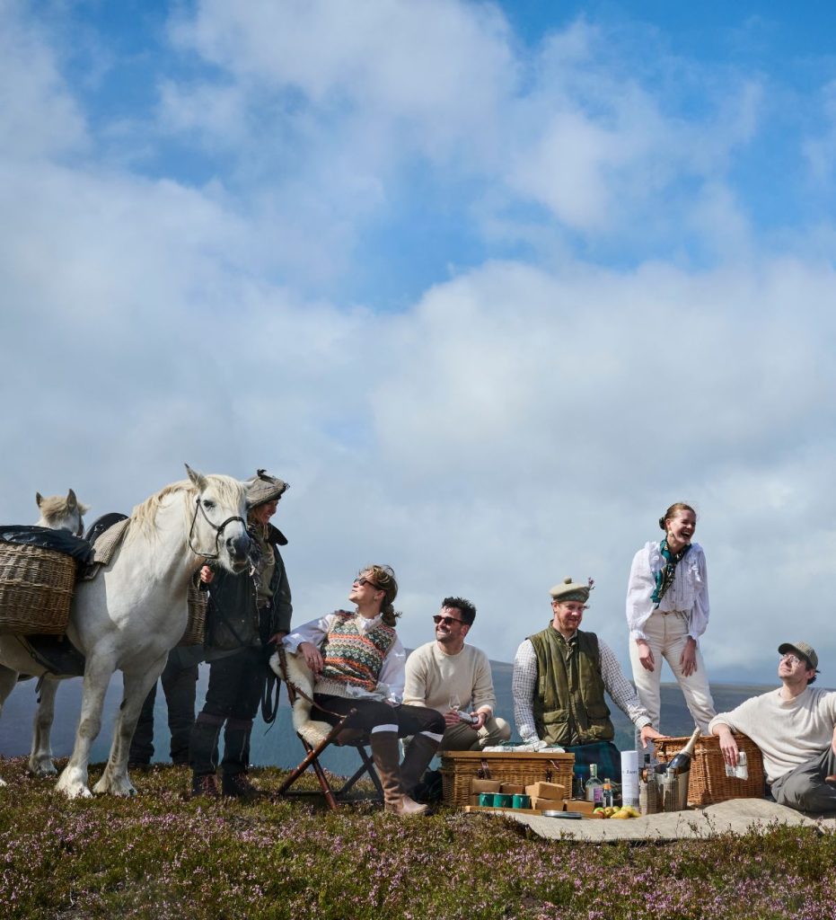 A group of friends enjoying a pony picnic with blue skies