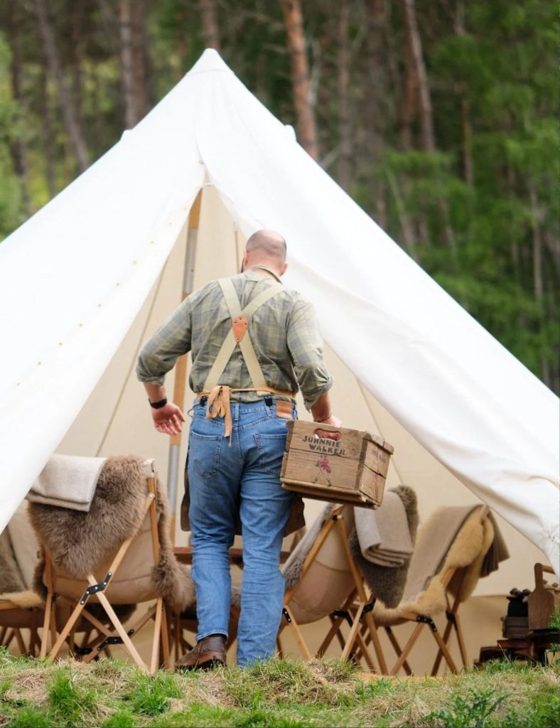 Experience guide Mikael is getting the bell tent ready for guests.