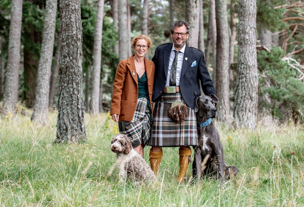 Iwan and Manuela Wirth with two dogs in the woods
