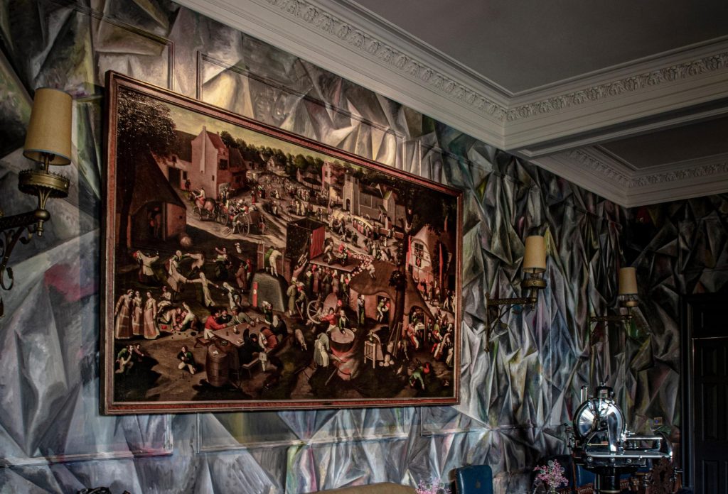 A Brueghel painting on a wall painted in an abstract style.