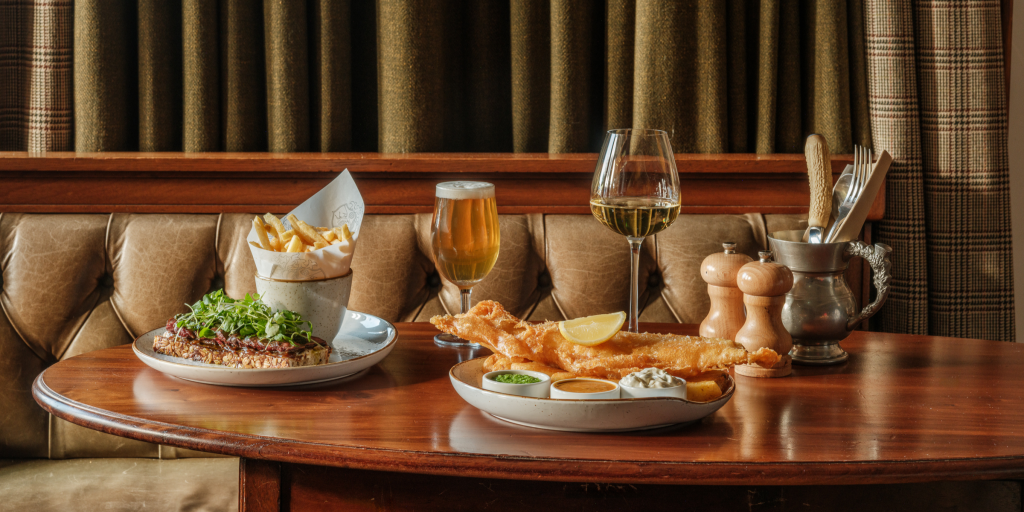 Pub dishes, beer and wine on a table in The Flying Stag