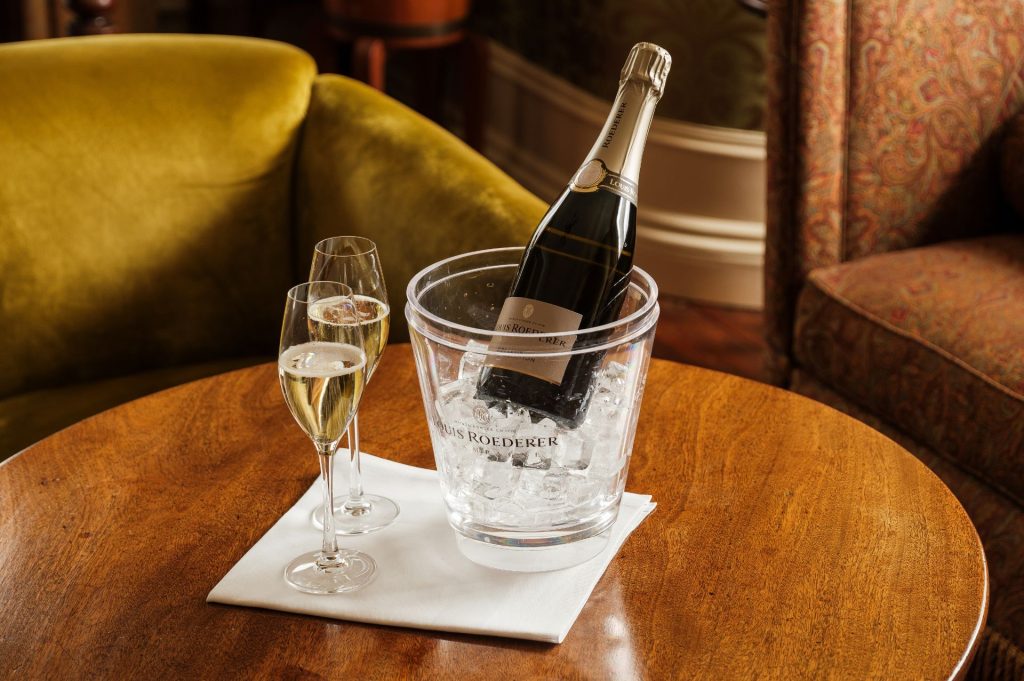 A bottle and two glasses of champagne.