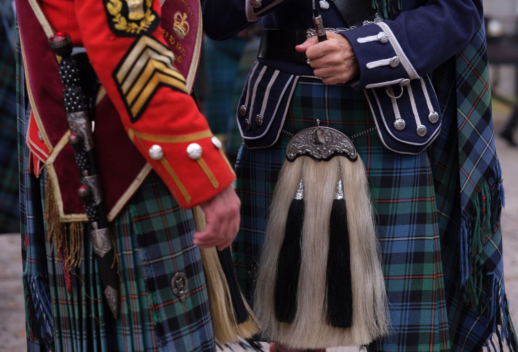 Close-up of two men in Scottish kilts and ceremonial attire