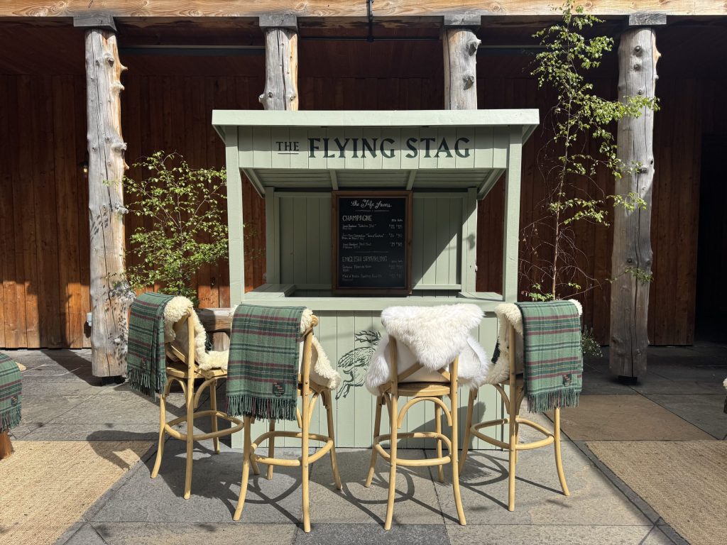 The oyster and champagne bar with wooden seating in a courtyard