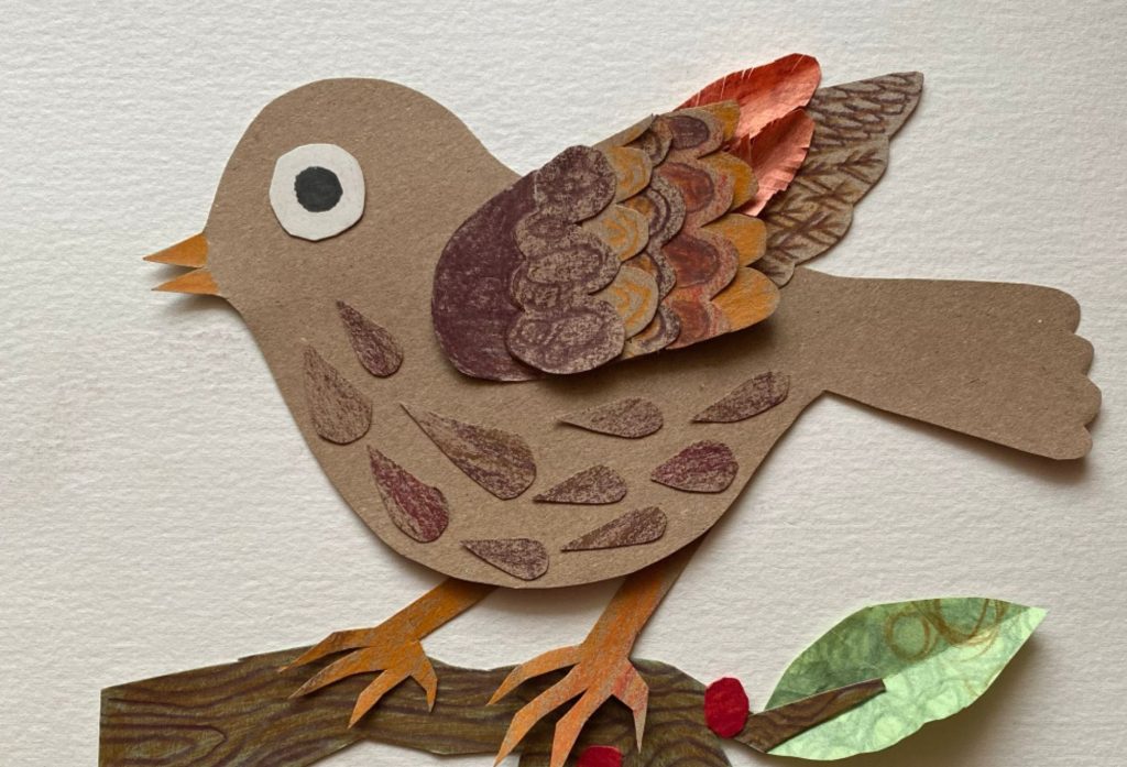 Handmade paper collage of a brown bird perched on branch.