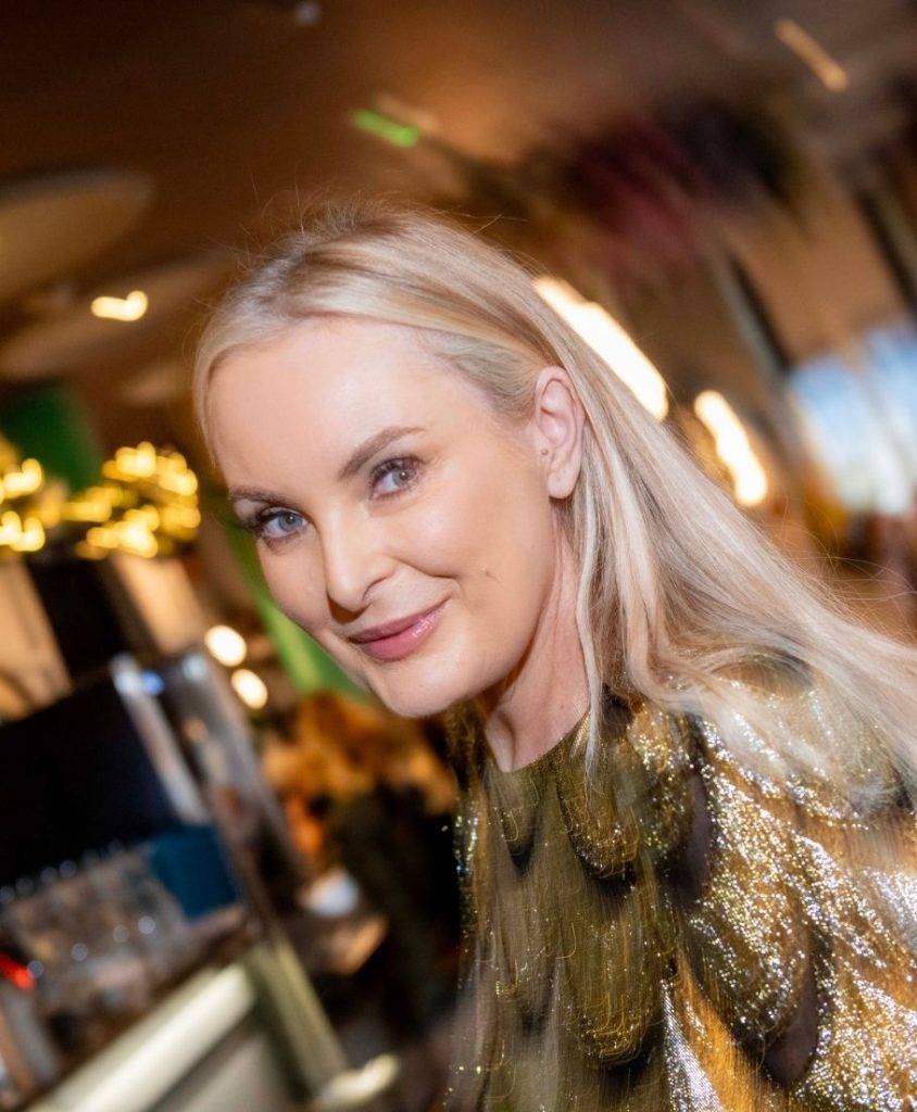 A smiling blonde woman