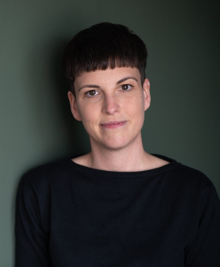 A woman wearing black with short dark hair