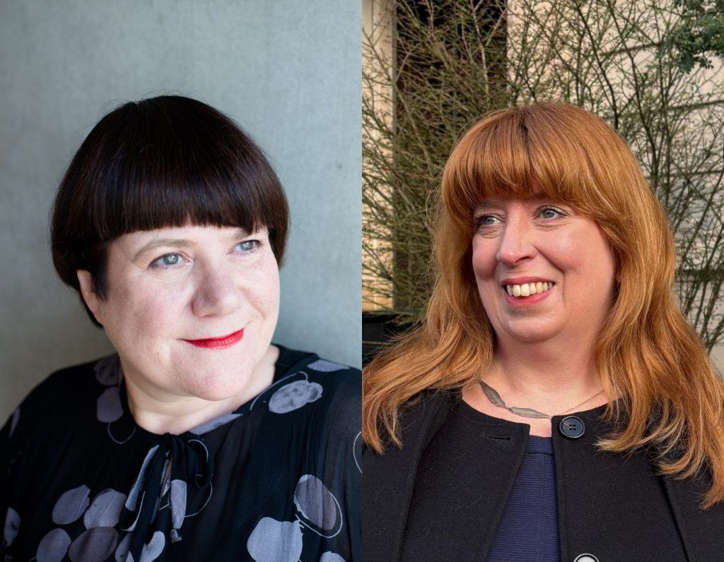 A woman with short back hair beside a woman with red hair