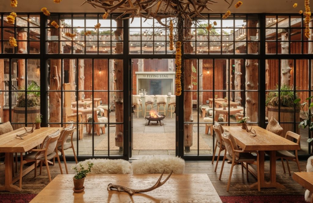 A view through glass doors to a courtyard with a fire pit