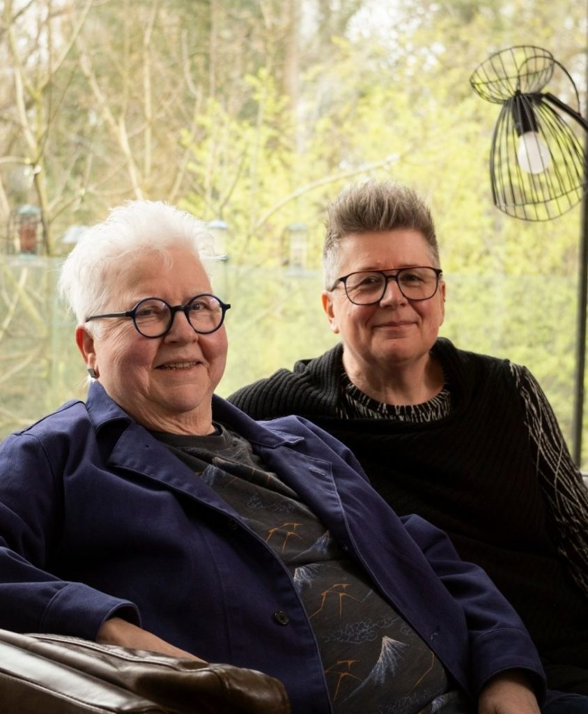 Two women sat in a garden.
