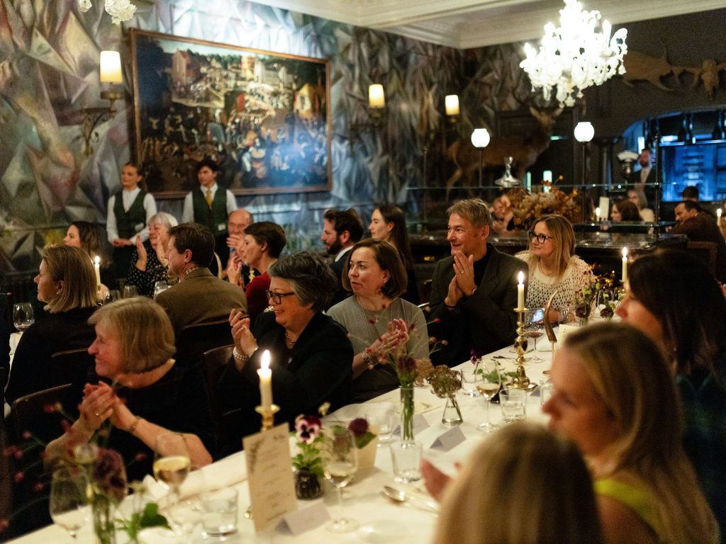 An evening gala dinner with people gathered at banquet tables