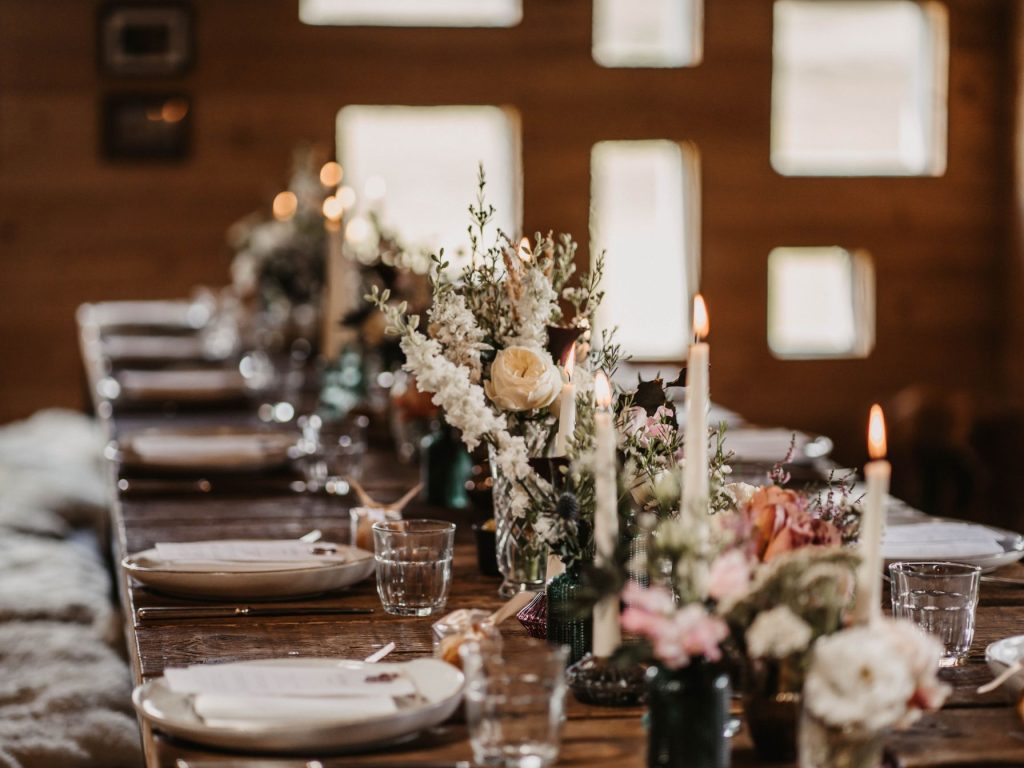 A dinner table set for a special occasion with flowers and candles