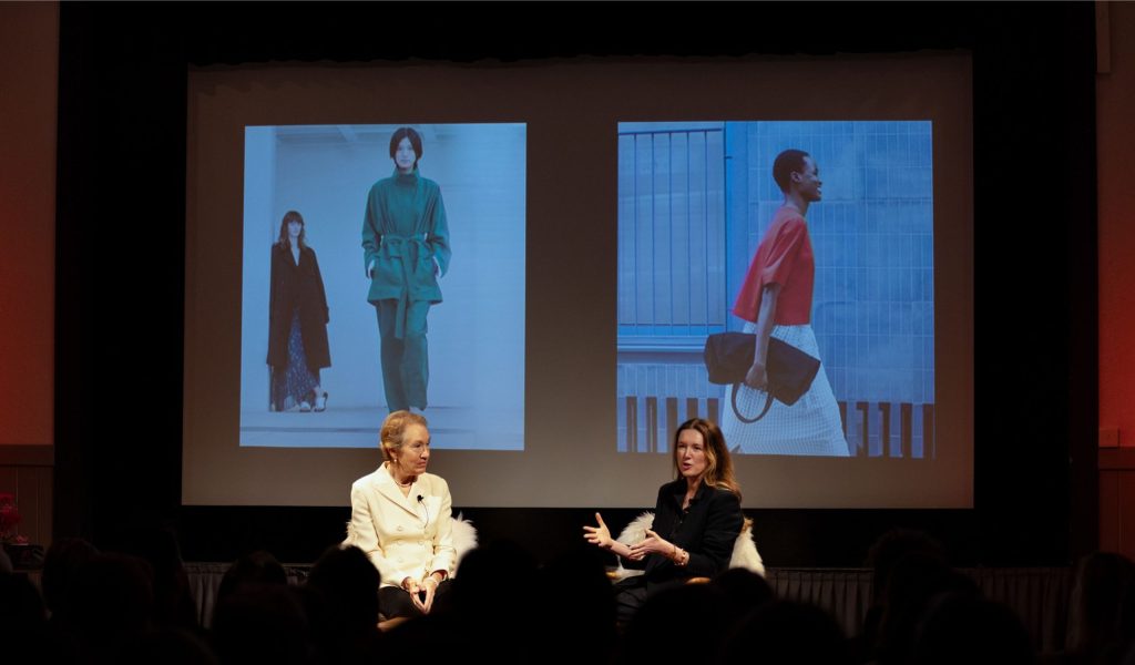Two women speaking on stage at the Festival of Fashion