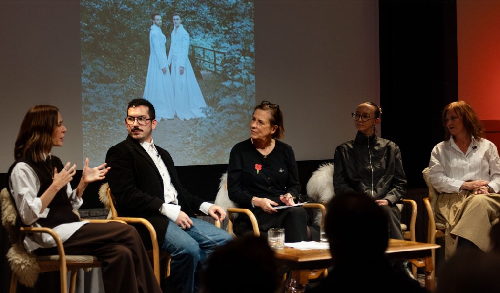 A panel of five people speaking on stage as part of the Festival of Fashion