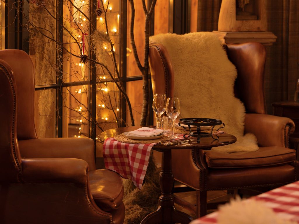 An armchair with fairy lights in the background