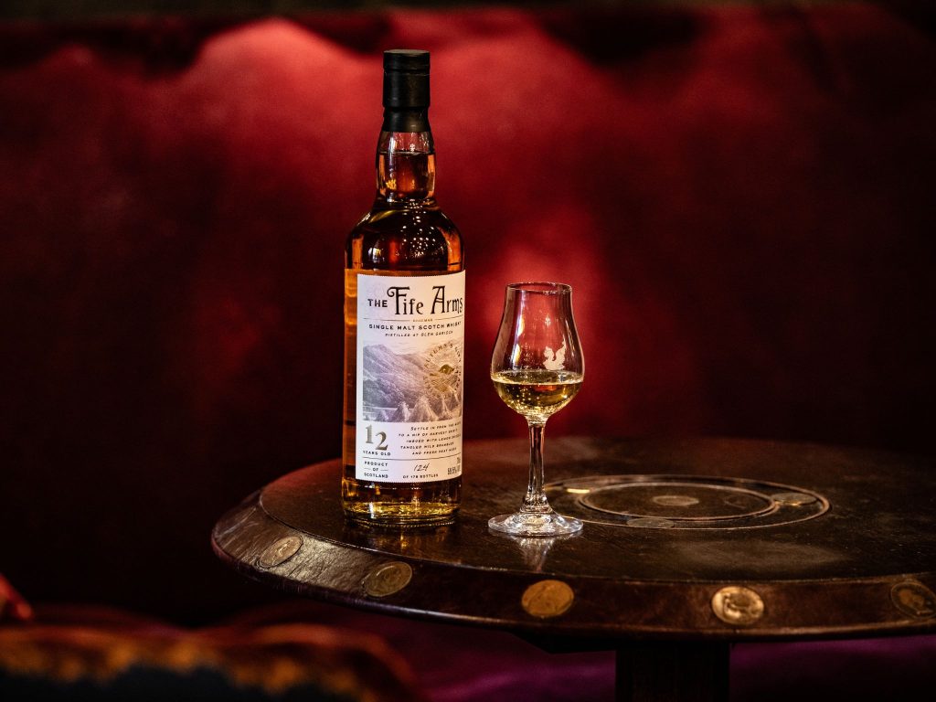 A bottle of Fife Arms whisky on a table with a glass