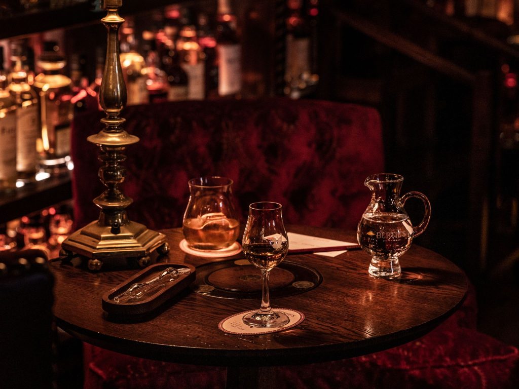 Glasses of whisky on a table in an atmospheric bar