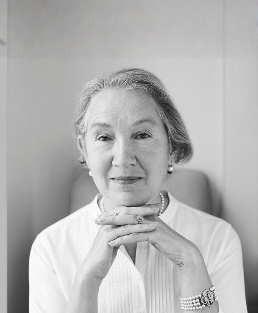 A black and white portrait with short hair and a white shirt.